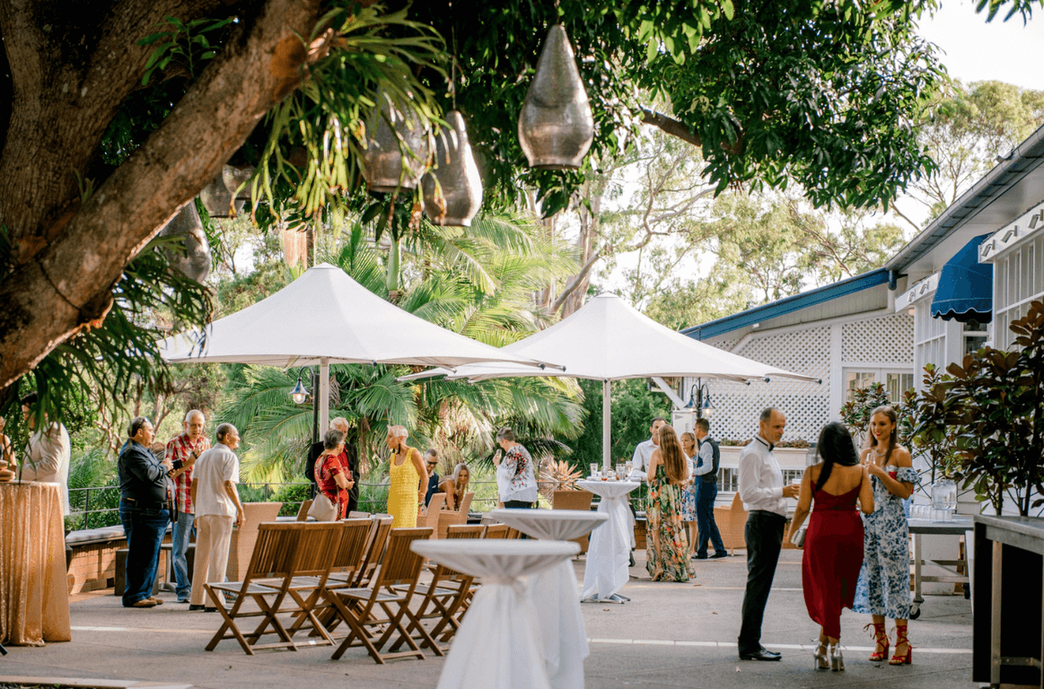 Guests at a private event outdoors with trees surrounding the space at Hillstone St Lucia.