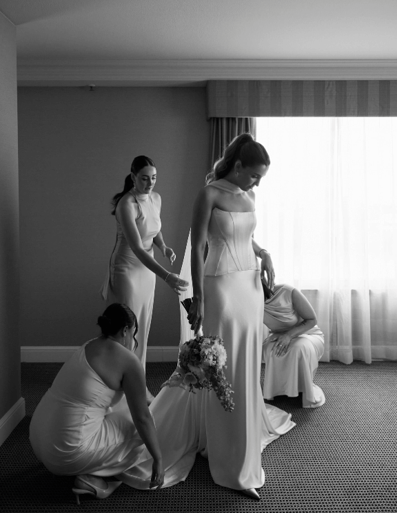 Bride and bridesmaids getting ready before wedding ceremony
