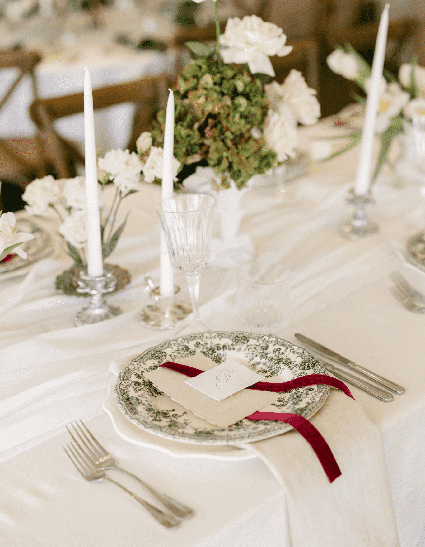 Wedding themes 2025 with red ribbon and green and white florals