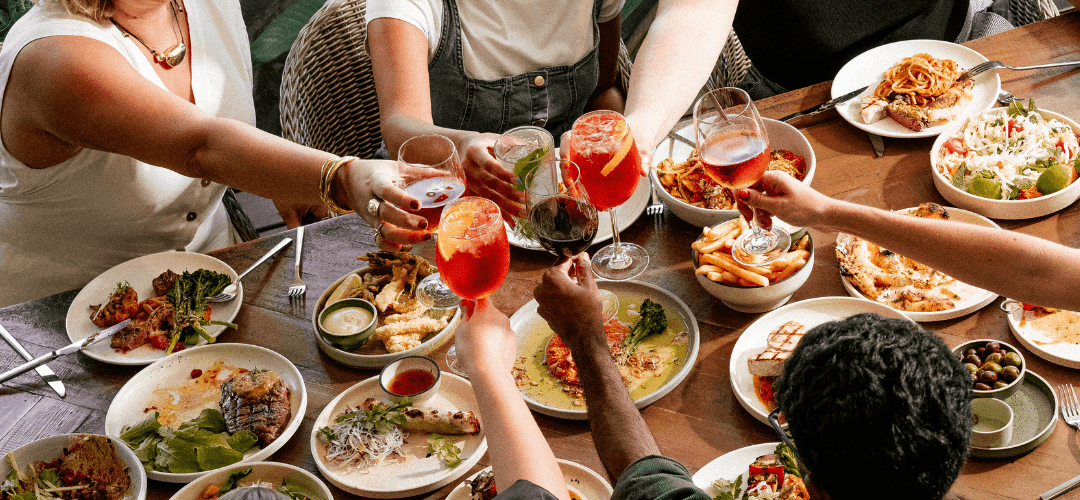 People gathered around a table at Hundred Acre Bar restaurant in St Lucia.