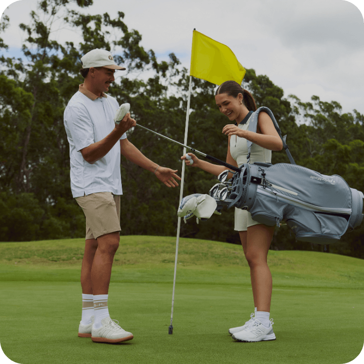 A boy and a girl at St Lucia Golf Links, Brisbane's best public golf course.