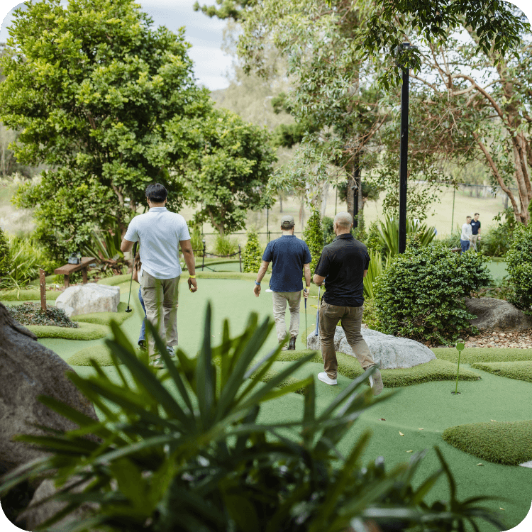 Men on a mini golf course during a team building event at St Lucia Mini Golf in Brisbane.