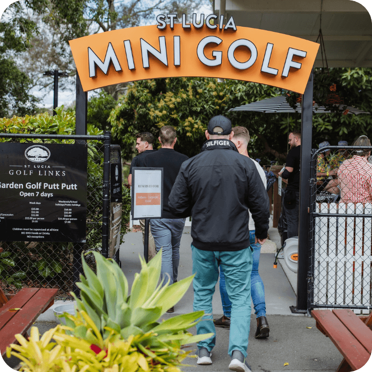 People walking into the entry way of St Lucia Mini Golf