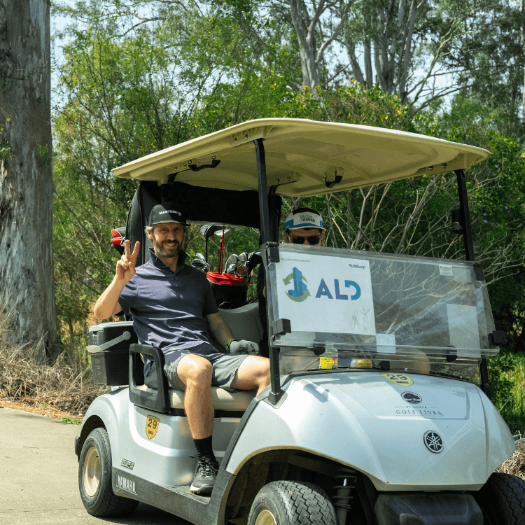 Man smiling driving a golf cart