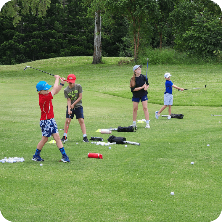 Four kids hitting golf balls at Brisbane golf course