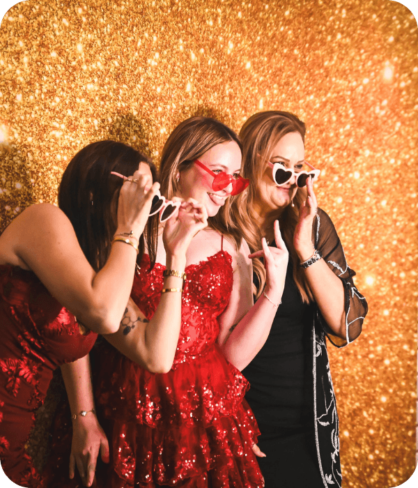 People posing at a photobooth at a university event in Brisbane