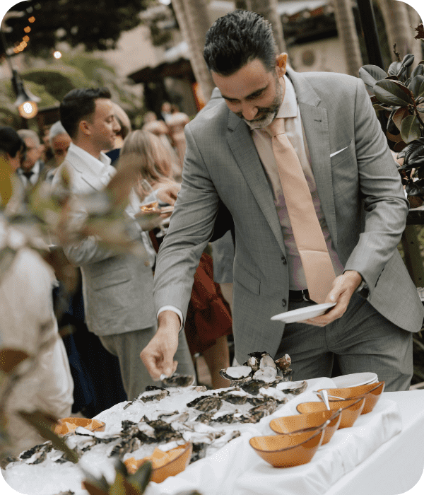 Man serving himself oysters at an oyster bar at a venue in Brisbane